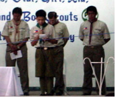Boy scout with three leaders in background