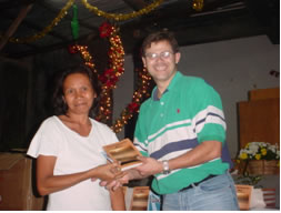 Paul presenting a book to a Filippino woman.