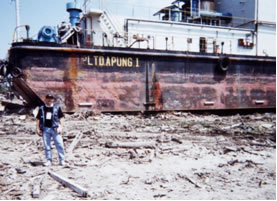 Large ocean barge sitting on rubble