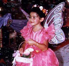 Abigail in pink butterfly costume holding basket of flowers