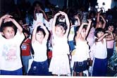 Filipino children with hands in air